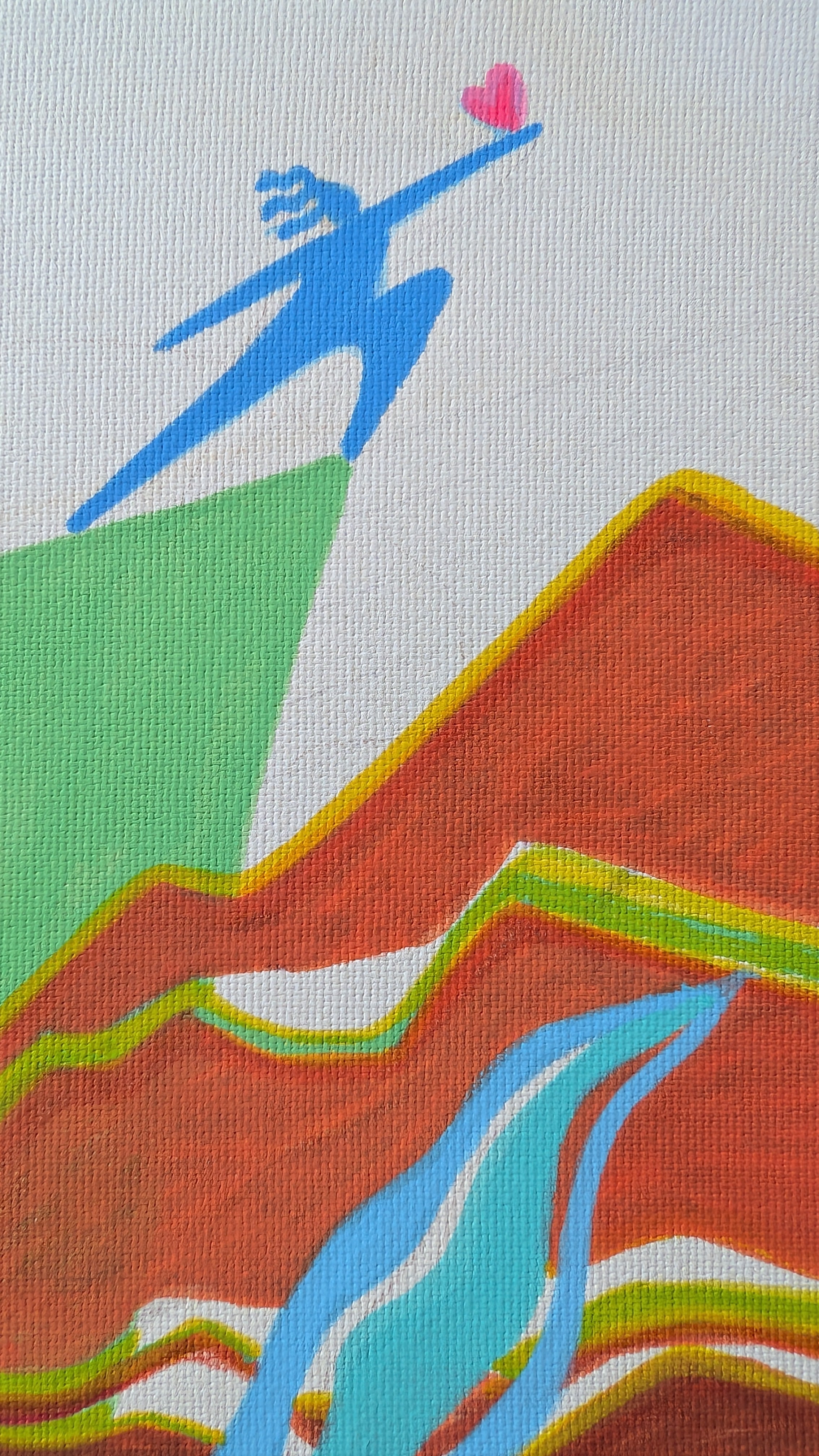 A close-up of a colorful abstract artwork on textured canvas, featuring a blue silhouette of a person reaching toward a small pink heart above layered orange, red, green, and blue mountain-like shapes on a white background. By Loveleen Saxena