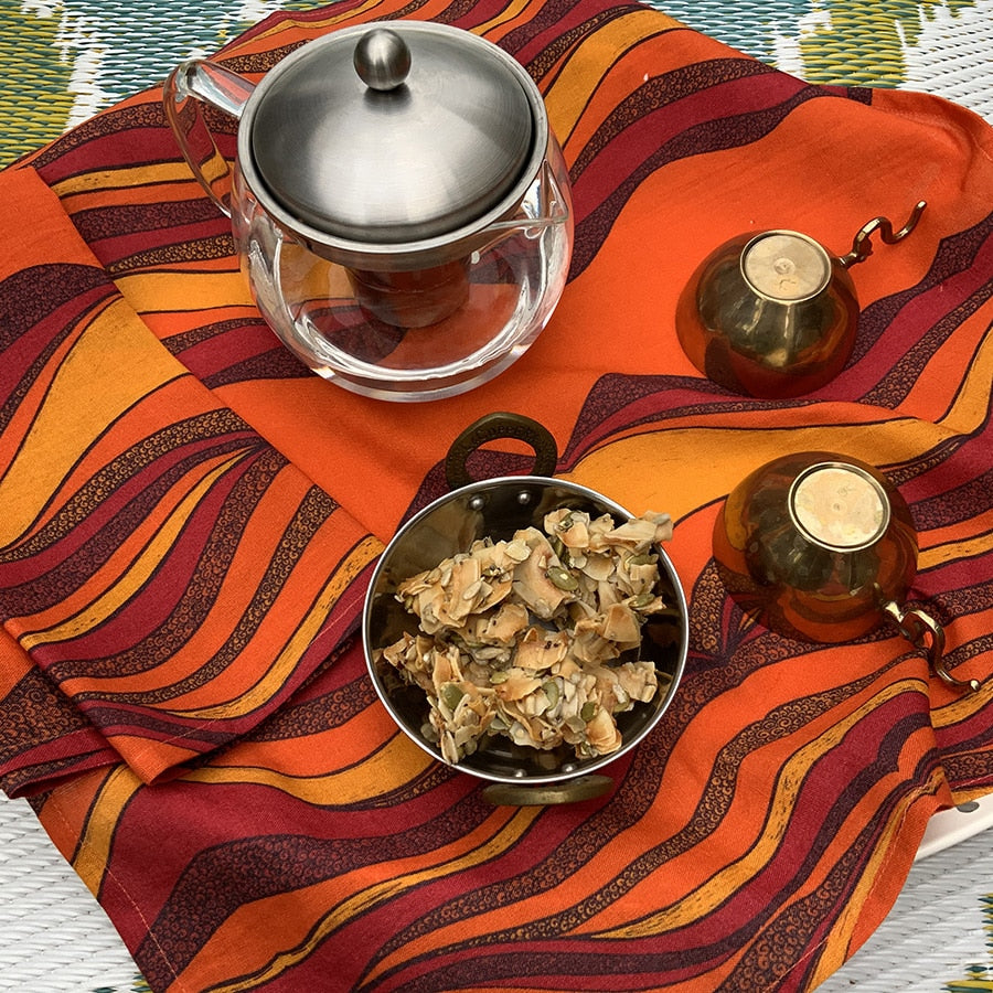 Orange table cover with kettle and food pot